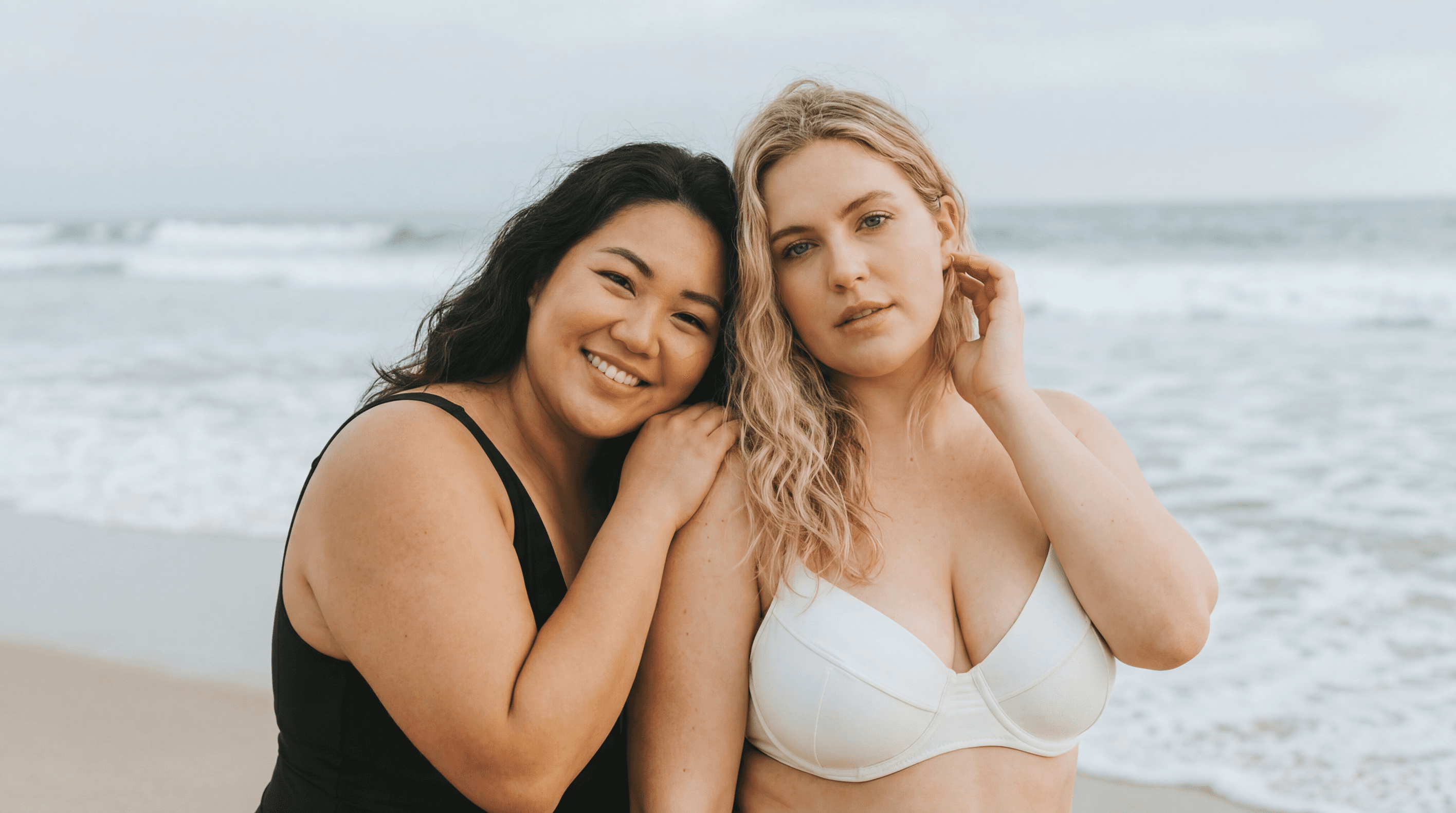 Two confident women smiling together at the beach, representing healthy weight management with SnagRx GLP-1 care